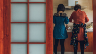 people standing in kitchen